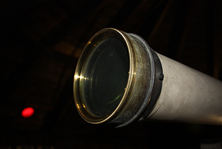 Telescope aperture with red observatory window in background (to preserve night-vision)